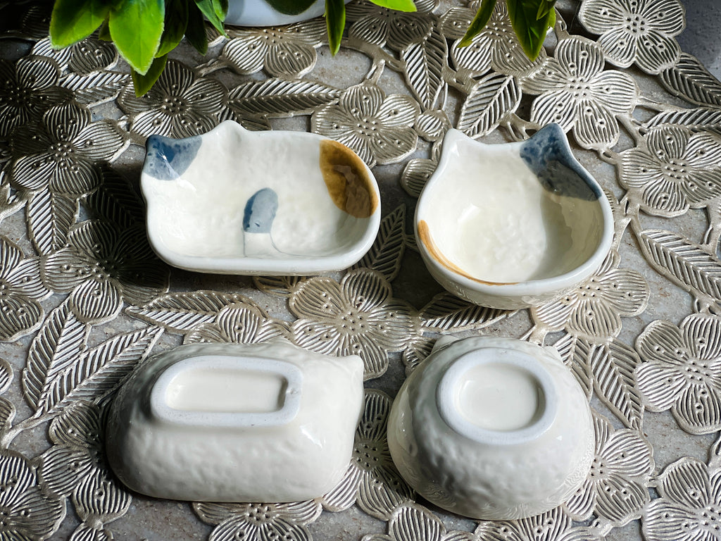 Set of ceramic bowls with decorative patterns on a textured surface