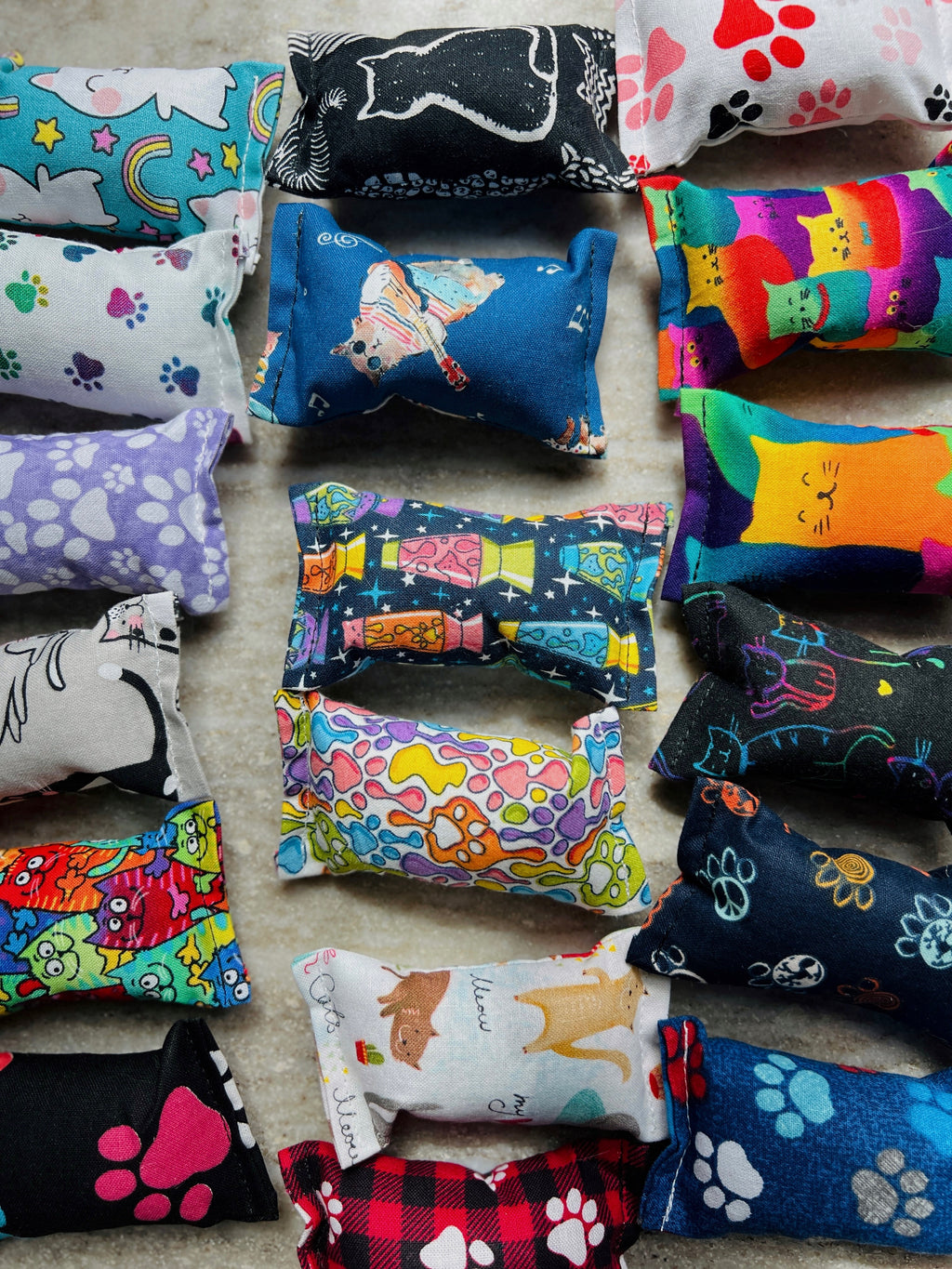 Colorful catnip toys with various designs on a neutral background