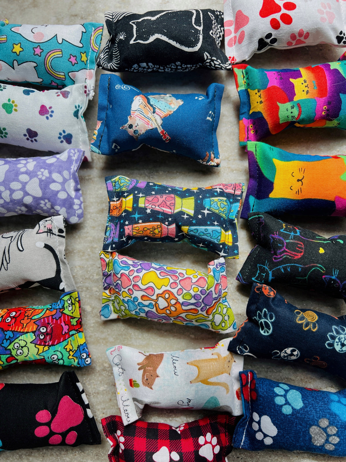 Colorful catnip toys with various designs on a neutral background