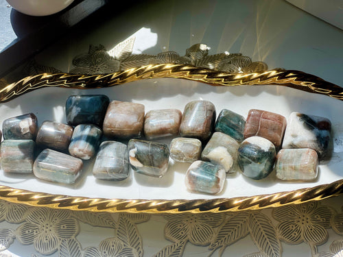 Decorative tray with decorative stones on a textured surface