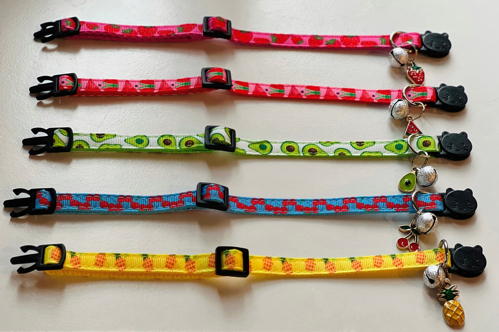Set of colorful cat collars with various patterns on a white background