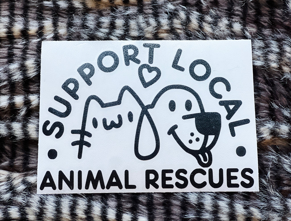 Sticker with text 'Support Local Animal Rescues' featuring a cat and dog illustration on a fur background.