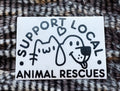 Sticker with text 'Support Local Animal Rescues' featuring a cat and dog illustration on a fur background.